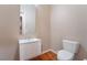 Bathroom with white vanity, toilet and hardwood floor at 2568 Dirleton Pl, Henderson, NV 89044