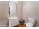 Cozy powder room featuring a pedestal sink and wood flooring at 2568 Dirleton Pl, Henderson, NV 89044