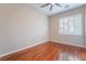 Well-lit bedroom featuring hardwood floors and a window with shutters at 2568 Dirleton Pl, Henderson, NV 89044