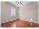 Well-lit bedroom with hardwood floors and plantation shutters at 2568 Dirleton Pl, Henderson, NV 89044