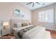 Bedroom featuring a ceiling fan and a window with plantation shutters at 2568 Dirleton Pl, Henderson, NV 89044