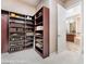 View of walk-in closet with extensive shelving and storage, leading to the bathroom at 2568 Dirleton Pl, Henderson, NV 89044