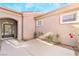 Private courtyard entry with an ornate gate and rose bushes at 2568 Dirleton Pl, Henderson, NV 89044