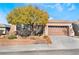 Single-story house with a brown garage door and a tree in the front yard at 2568 Dirleton Pl, Henderson, NV 89044