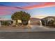 Single-story home with landscaped yard, two-car garage, and inviting front porch at 2568 Dirleton Pl, Henderson, NV 89044