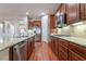 Modern kitchen with stainless steel appliances and hardwood floors at 2568 Dirleton Pl, Henderson, NV 89044