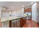 Kitchen island with granite countertop and stainless steel dishwasher at 2568 Dirleton Pl, Henderson, NV 89044