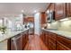 Modern kitchen boasting granite countertops and hardwood floors at 2568 Dirleton Pl, Henderson, NV 89044