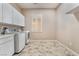 Bright laundry room with cabinets and tiled floors at 2568 Dirleton Pl, Henderson, NV 89044