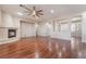 Spacious living room with hardwood floors, a fireplace, and ceiling fan at 2568 Dirleton Pl, Henderson, NV 89044