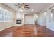 Spacious living room with hardwood floors, a fireplace, and ceiling fan at 2568 Dirleton Pl, Henderson, NV 89044