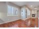 Bright living room with hardwood floors, fireplace, and large windows at 2568 Dirleton Pl, Henderson, NV 89044