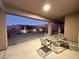 Relaxing backyard patio with seating area and landscape lighting at 2568 Dirleton Pl, Henderson, NV 89044