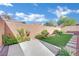 Landscaped backyard with artificial turf and flagstone patio at 2736 Mintlaw Ave, Henderson, NV 89044