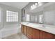 Bathroom with double vanity, bathtub, and large mirror at 2736 Mintlaw Ave, Henderson, NV 89044