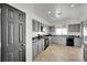 Kitchen with gray cabinets, black countertops, and stainless steel appliances at 2736 Mintlaw Ave, Henderson, NV 89044