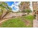 Landscaped backyard with grassy lawn and mature trees at 3128 Pelican Beach Dr, Las Vegas, NV 89117