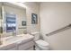 Small bathroom with toilet, sink, and grab bar at 3128 Pelican Beach Dr, Las Vegas, NV 89117