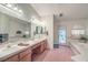 Main bathroom with dual sinks, and a large bathtub at 3128 Pelican Beach Dr, Las Vegas, NV 89117