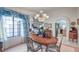 Elegant dining room with chandelier and oval wood table at 3128 Pelican Beach Dr, Las Vegas, NV 89117