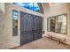 Front entry with decorative iron doors and a stone bench at 3128 Pelican Beach Dr, Las Vegas, NV 89117