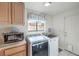 Laundry room with washer, dryer, and cabinets at 3128 Pelican Beach Dr, Las Vegas, NV 89117