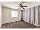 Bedroom with ceiling fan, gray curtains, and carpet at 332 S Buffalo Dr # 202, Las Vegas, NV 89145