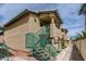 Tan stucco building with teal accents and stairs at 332 S Buffalo Dr # 202, Las Vegas, NV 89145