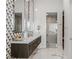 Bathroom with double sink vanity, geometric wall design, and glass-enclosed shower at 371 Tranquil Peak Ct, Henderson, NV 89012