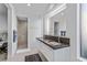 Bathroom with a double vanity, stone countertop, and a glass enclosed shower at 371 Tranquil Peak Ct, Henderson, NV 89012