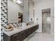 Modern bathroom with double vanity, unique triangle tile, and a glass enclosed shower at 371 Tranquil Peak Ct, Henderson, NV 89012