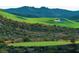 Elevated view of a challenging golf course hole with sand traps and mountain backdrop at 371 Tranquil Peak Ct, Henderson, NV 89012