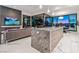 Stylish kitchen with marble island, sleek cabinetry, and floor-to-ceiling glass doors that open to outside seating at 371 Tranquil Peak Ct, Henderson, NV 89012