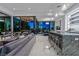 Open-concept kitchen and living space with floor-to-ceiling glass doors leading to an outdoor dining area at 371 Tranquil Peak Ct, Henderson, NV 89012