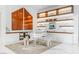 Bright living room with modern decor featuring a transparent piano and floating shelves with accent lighting at 371 Tranquil Peak Ct, Henderson, NV 89012