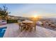 An outdoor dining area with amazing views of the cityscape and mountains at sunrise at 371 Tranquil Peak Ct, Henderson, NV 89012