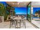 Outdoor dining area with city views, modern seating, and a built-in grill at 371 Tranquil Peak Ct, Henderson, NV 89012