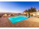 A luxurious backyard with a pool, hot tub, outdoor seating, dining table and an incredible view at 371 Tranquil Peak Ct, Henderson, NV 89012