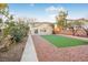 Artificial turf backyard with two-story home at 3748 Honey Crest Dr, Las Vegas, NV 89135