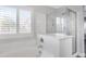 Bathroom with soaking tub, shower, and window with shutters at 3748 Honey Crest Dr, Las Vegas, NV 89135