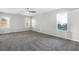 Bright bedroom featuring grey carpet, ceiling fan, and large windows at 3748 Honey Crest Dr, Las Vegas, NV 89135