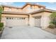 Two-story house with beige exterior, two-car garage, and landscaping at 3748 Honey Crest Dr, Las Vegas, NV 89135