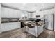 Modern kitchen with white cabinets, granite island, and stainless steel appliances at 3748 Honey Crest Dr, Las Vegas, NV 89135