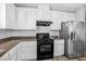 Modern kitchen featuring granite countertops, stainless steel appliances, and white cabinets at 3748 Honey Crest Dr, Las Vegas, NV 89135