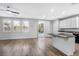 Modern kitchen with white cabinets, granite island, and wood floors at 3748 Honey Crest Dr, Las Vegas, NV 89135