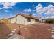 Backyard with gravel landscaping, covered patio, and a small walkway at 392 Dooley Dr, Henderson, NV 89015