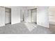 Well-lit bedroom with gray carpet, mirrored closet doors and access to bathroom at 392 Dooley Dr, Henderson, NV 89015