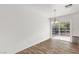 Bright dining area with wood-look floors and sliding glass doors to backyard at 392 Dooley Dr, Henderson, NV 89015