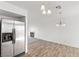 Dining area with wood-look floors and a view of the living room and kitchen at 392 Dooley Dr, Henderson, NV 89015