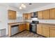 Kitchen with wood cabinets, stainless steel appliances, and wood-look flooring at 392 Dooley Dr, Henderson, NV 89015